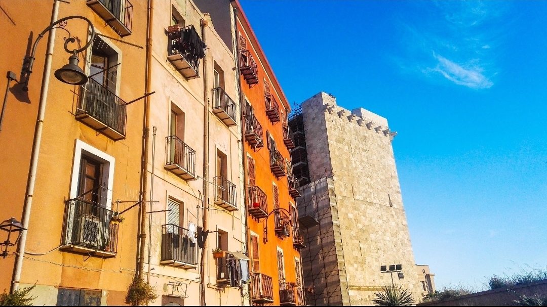 Colorful houses and a medieval tower in Cagliari’s old town