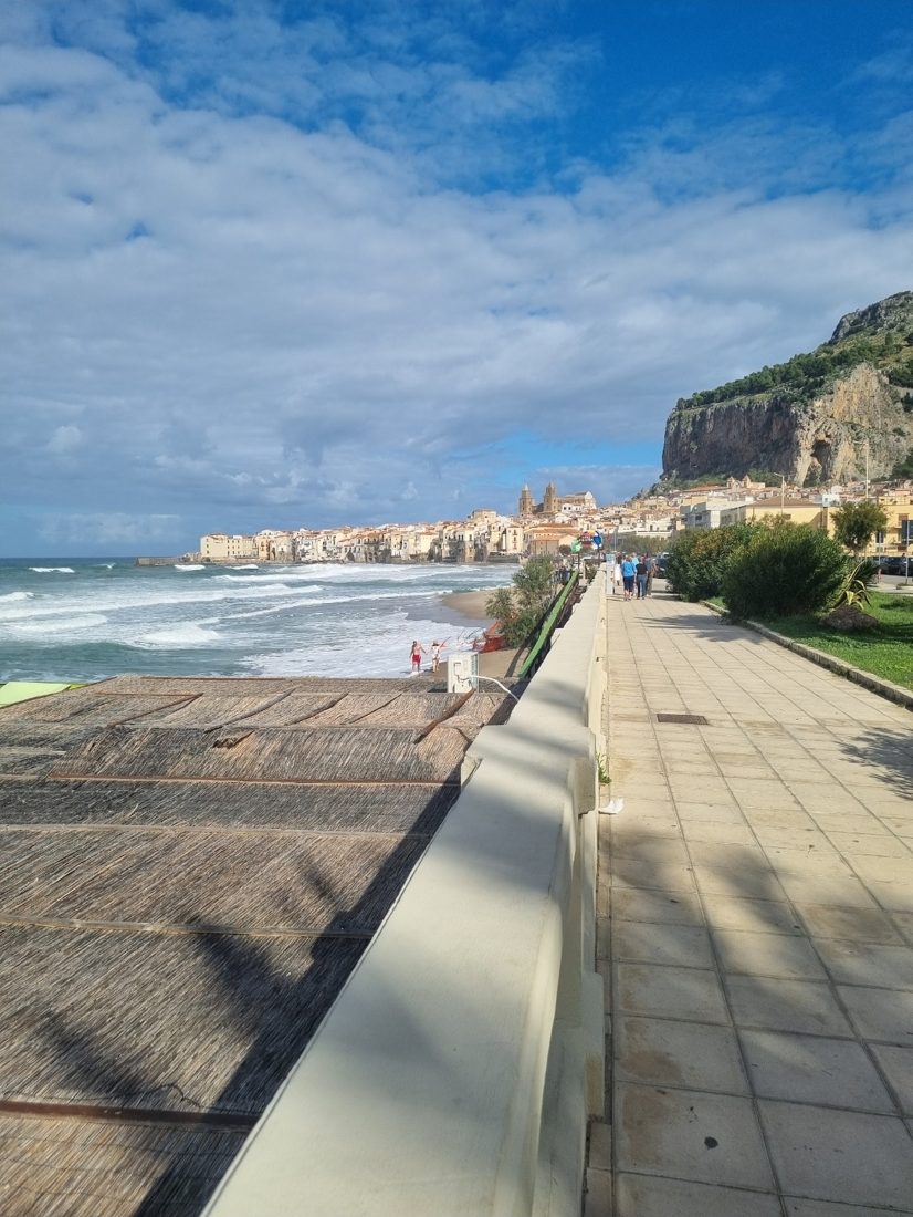 Cefalù’s seafront and sandy beach, with the old town behind