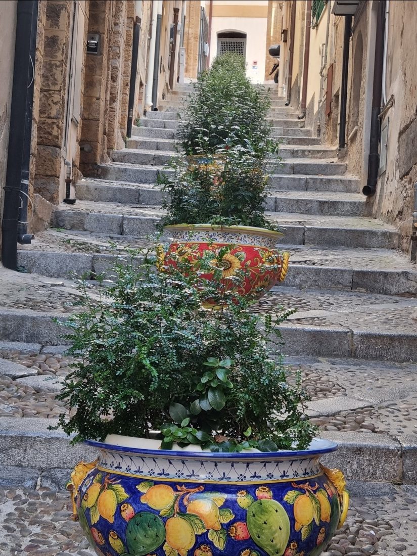 Painted ceramic pots on steps in the old town
