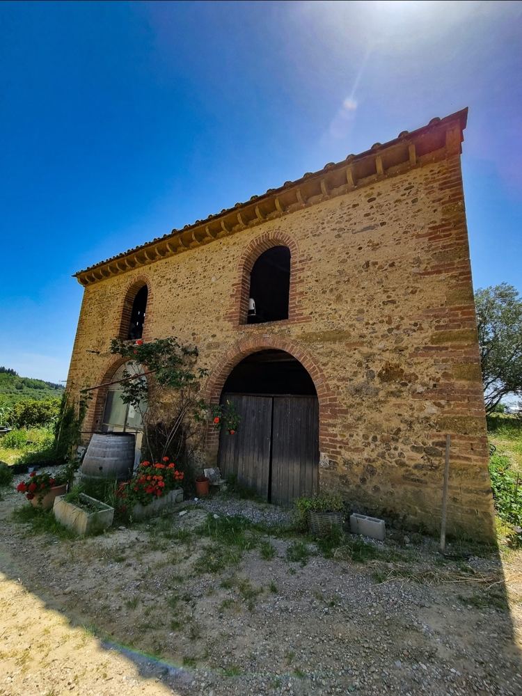 An old stone building on a wine estate