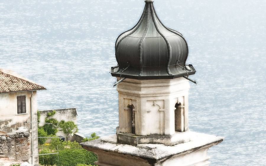 Garda: a bell tower and tiled roofs above the lake.