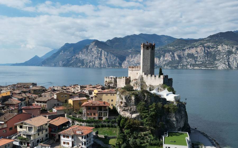 Malcesine: the Scaligero castle on its rock, with Lake Garda and the mountains behind.