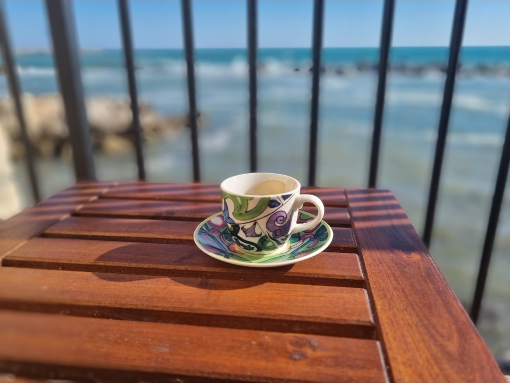 Espresso on a balcony over the sea in Molfetta