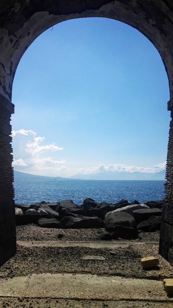 The Bay of Naples through a stone arch