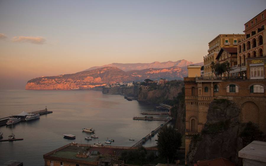 Sorrento: from the cliff edge down to the Marina Piccola harbor and the coast at sunset.