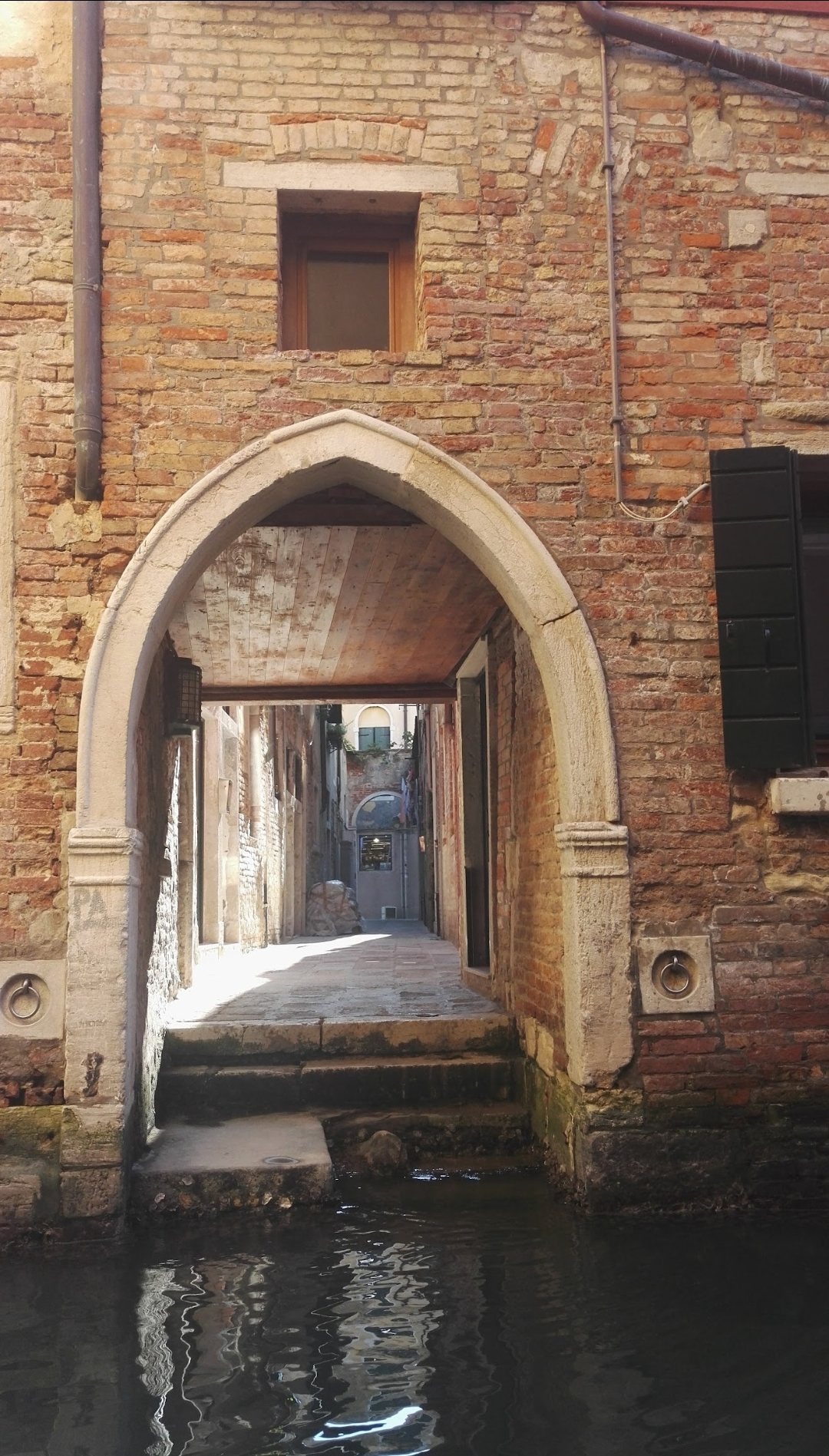 An archway with steps straight into the canal