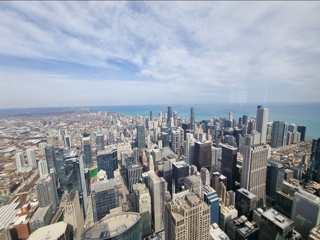 Chicago skyline from above, with Lake Michigan behind